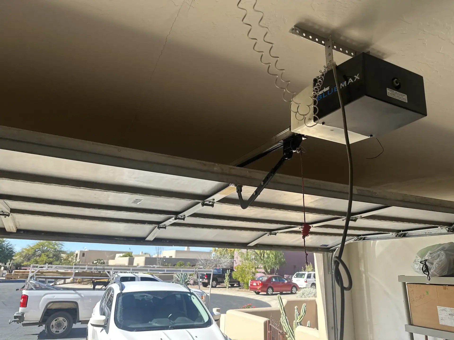 Garage door opener mounted under a carport ceiling