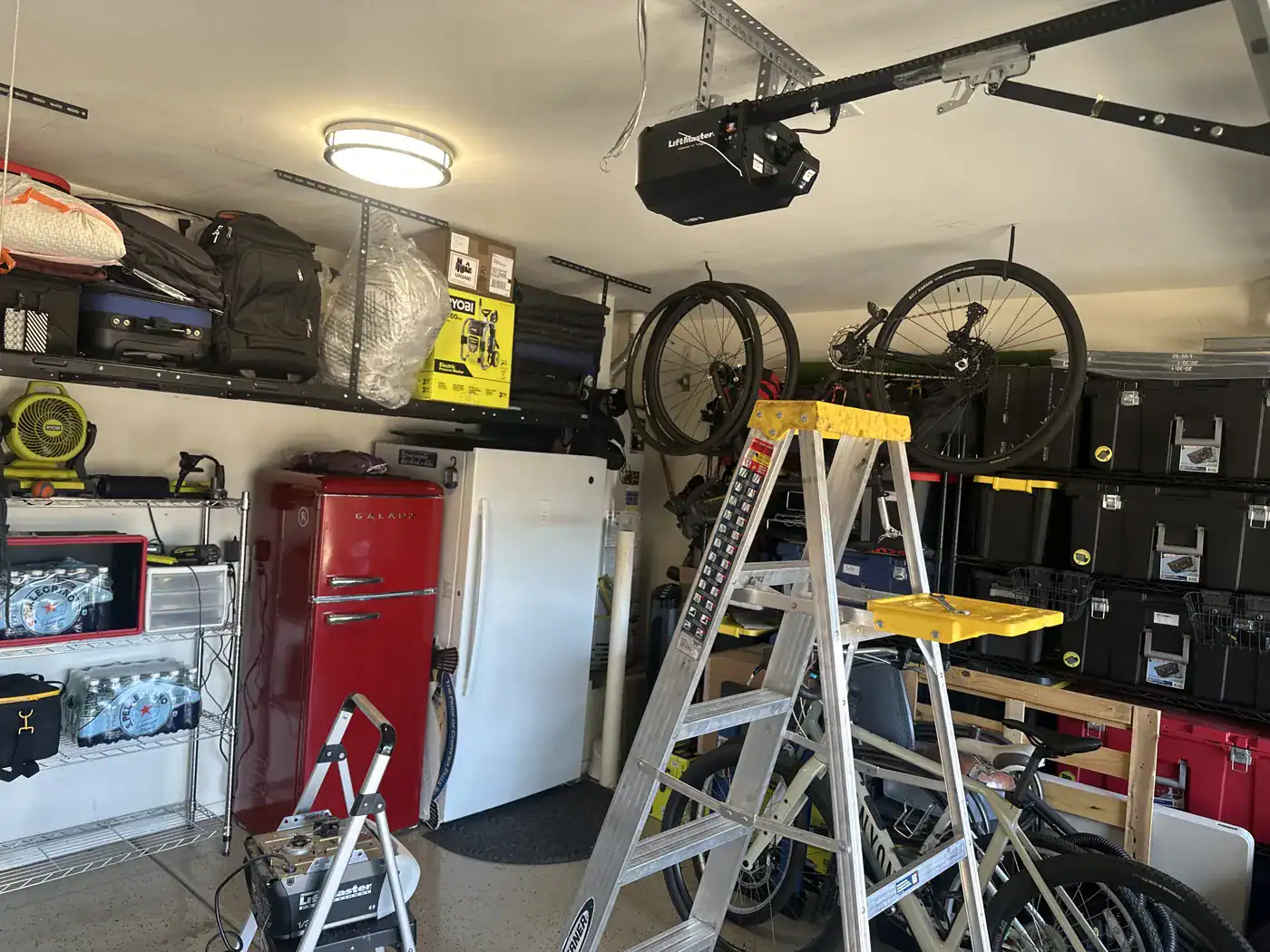 Garage workshop with a ladder set up under the opener