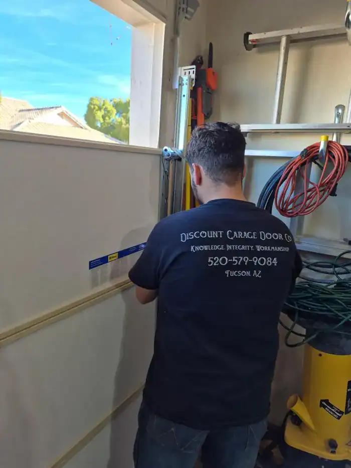Discount Door Service technician leveling a garage door track