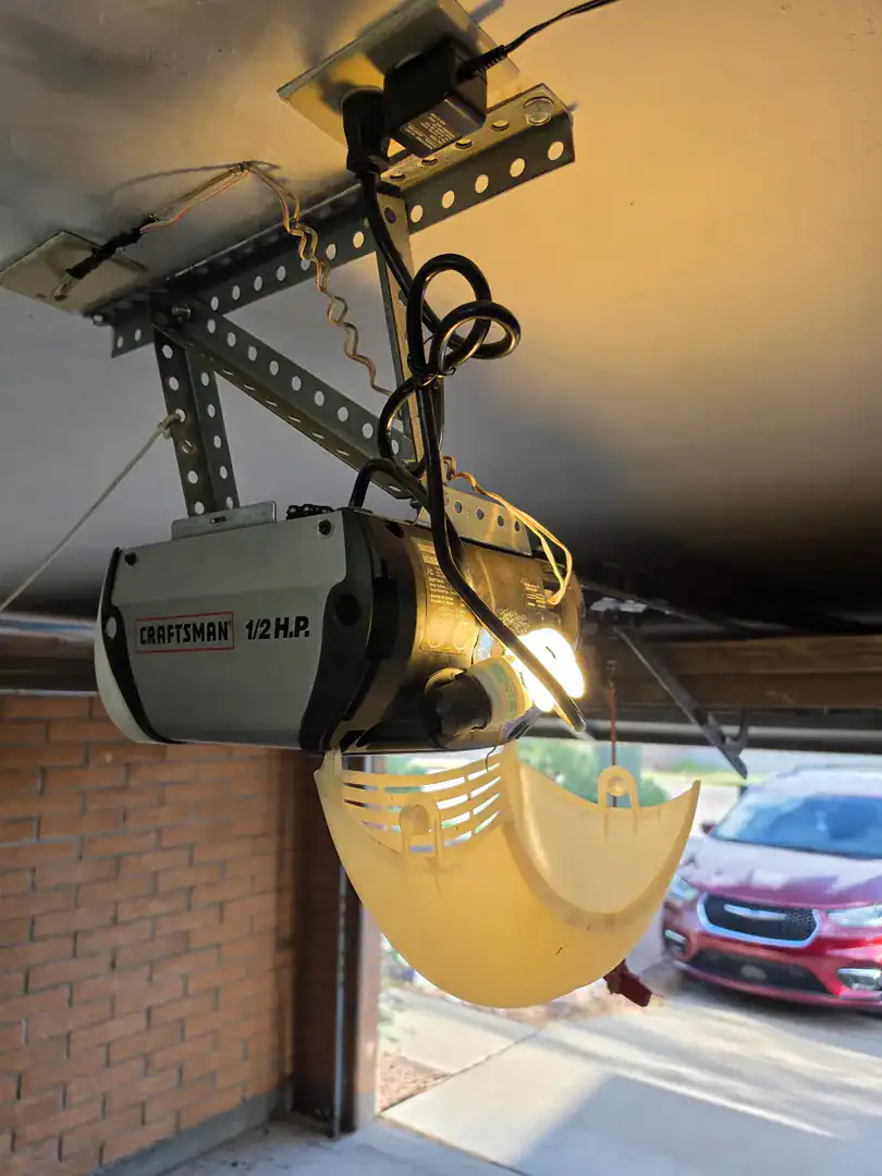 Craftsman opener with its light cover open during a repair