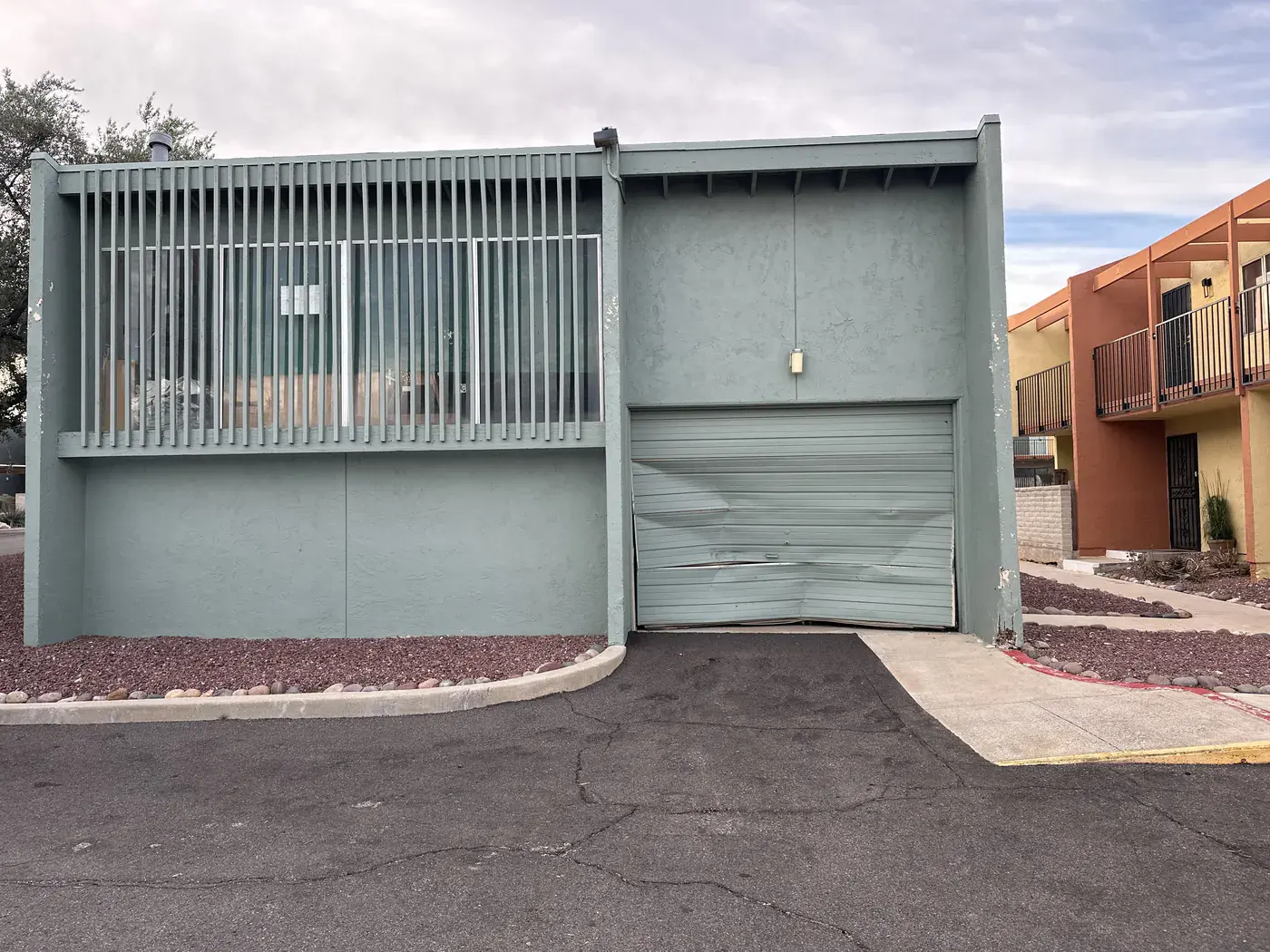 Dented roll-up door on a commercial building